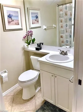 a bathroom with a sink mirror and toilet