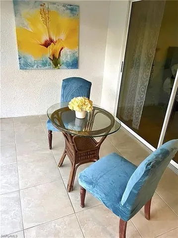 a view of a yard with plants and large trees