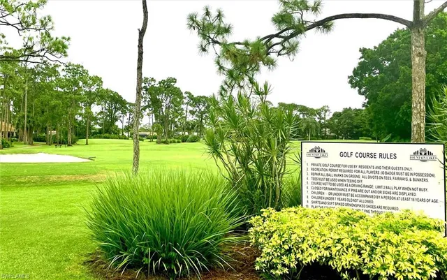 a grassy field with some trees in the background