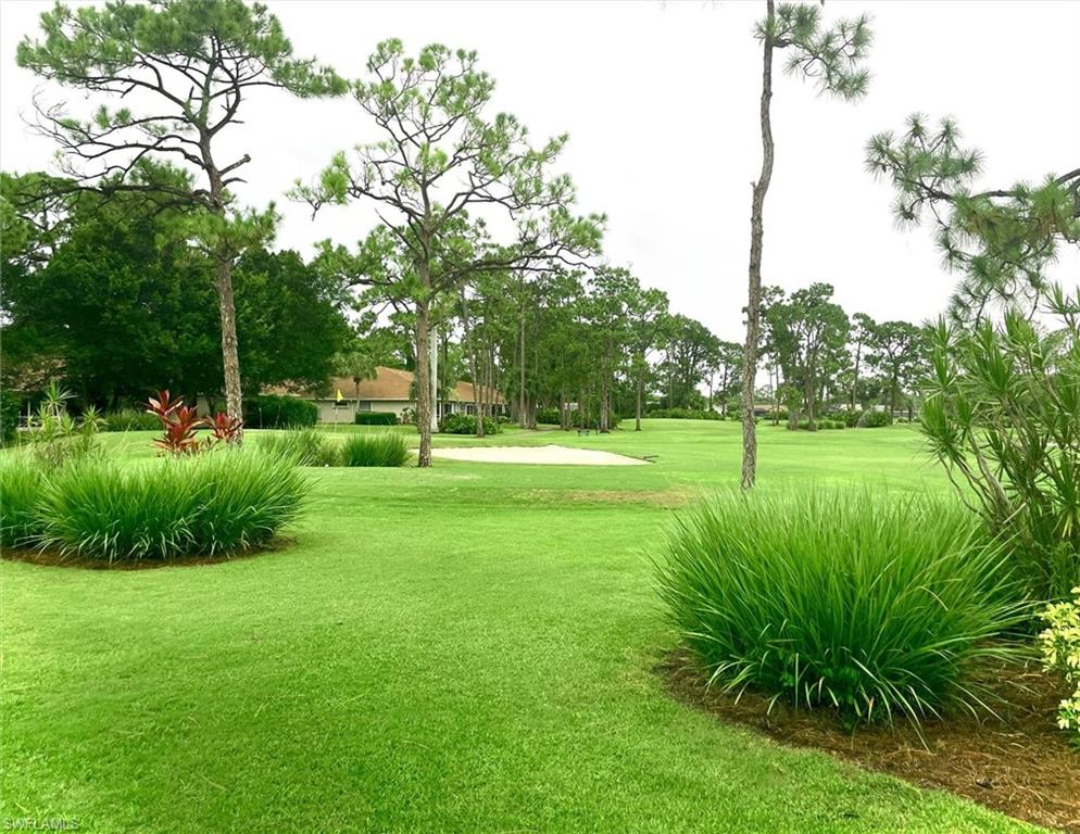3634 Stone Way Estero, FL 33928 - Photo 22 of 27 a grassy field with some trees in the background