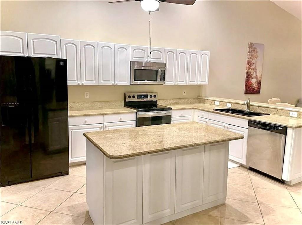 3634 Stone Way Estero, FL 33928 - Photo 3 of 27 a kitchen with stainless steel appliances granite countertop a sink stove and refrigerator