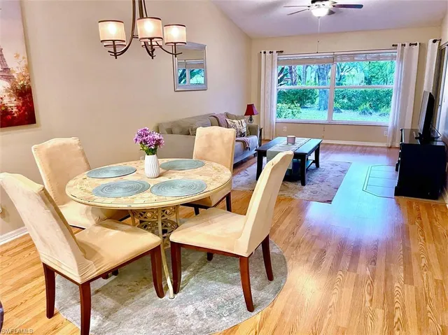 a dining room with furniture and wooden floor