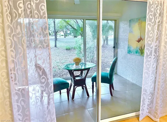 a view of a dining room with furniture a chandelier and wooden floor