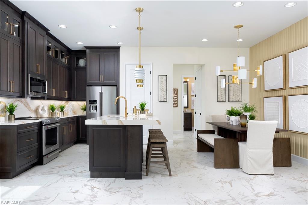 7184 Cayo Coco Lane Naples, FL 34113 - Photo 2 of 19 a large kitchen with a table and chairs