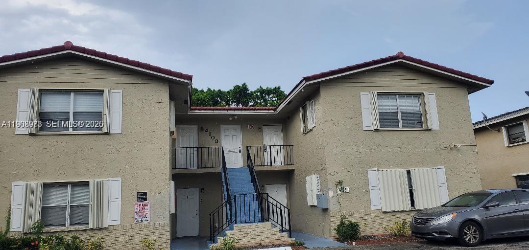 4103 Riverside Drive, Unit 4 Coral Springs, FL 33065 - Photo 2 of 6 a view of a car parked in front of a house