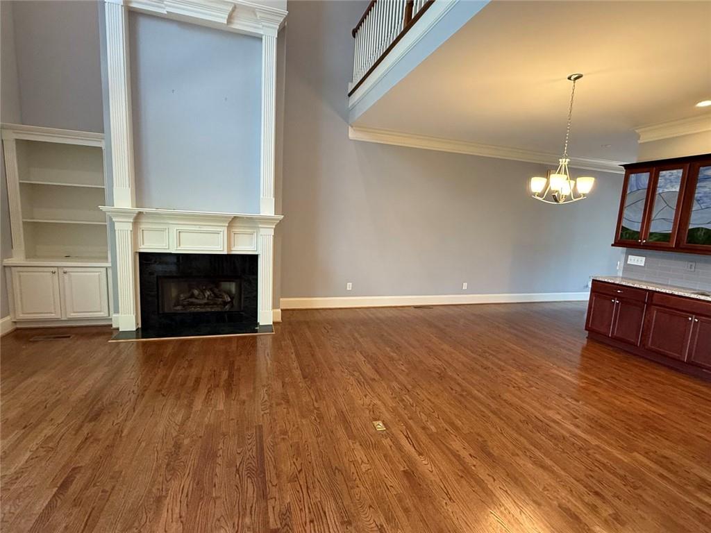 1950 Buford Dam Road, Unit 202 Cumming, GA 30041 - Photo 12 of 40 a view of a livingroom with wooden floor fireplace and a window