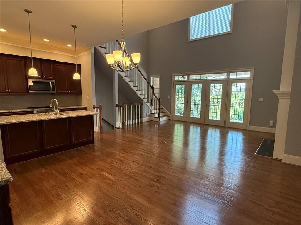 1950 Buford Dam Road, Unit 202 Cumming, GA 30041 - Photo 13 of 40 a view of a kitchen with furniture and a floor to ceiling window