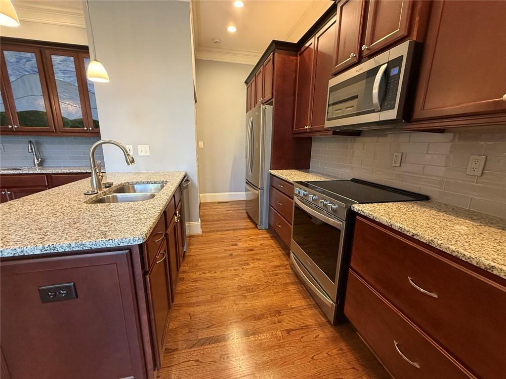1950 Buford Dam Road, Unit 202 Cumming, GA 30041 - Photo 15 of 40 a kitchen with stainless steel appliances granite countertop a sink stove and microwave