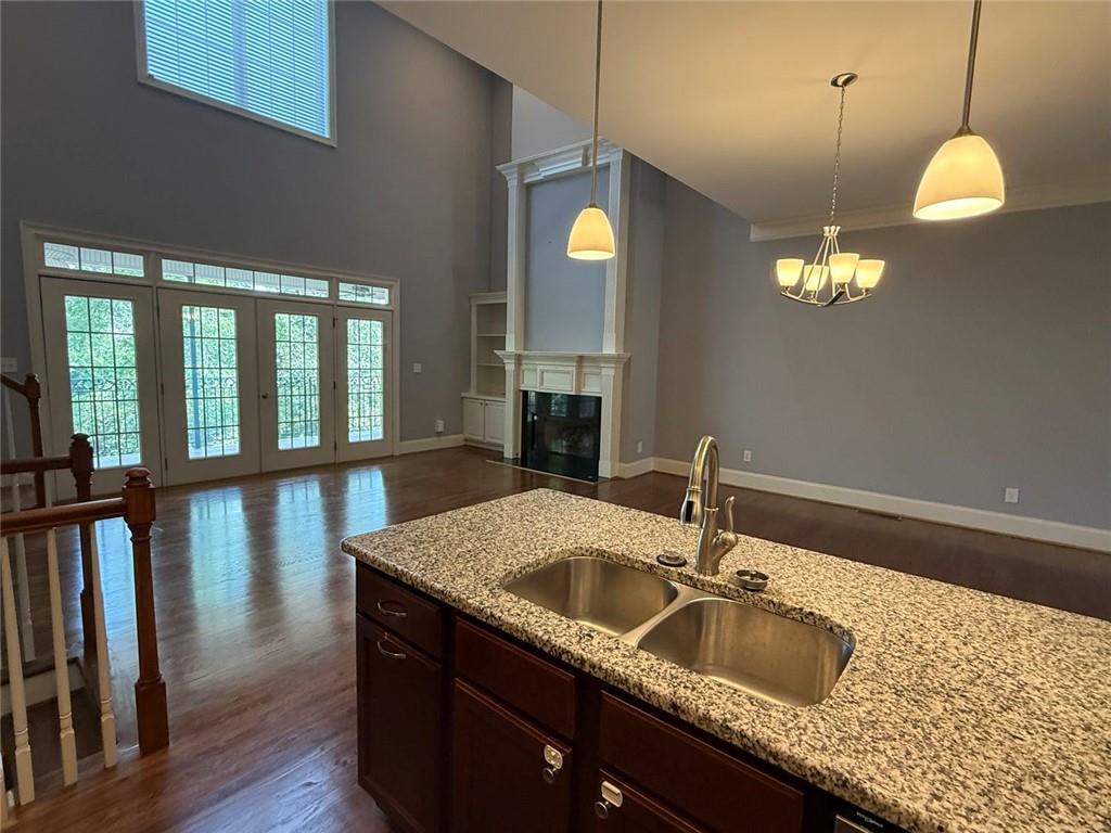 1950 Buford Dam Road, Unit 202 Cumming, GA 30041 - Photo 18 of 40 a kitchen with granite countertop a sink a counter space and wooden floor