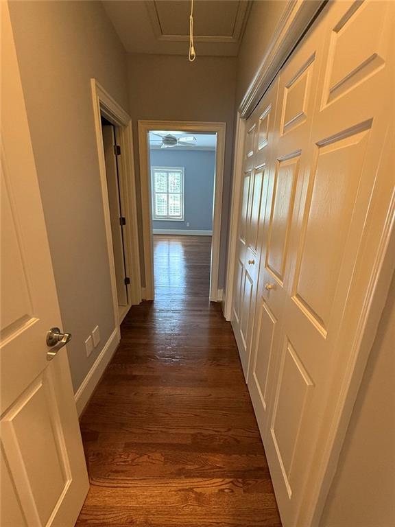 1950 Buford Dam Road, Unit 202 Cumming, GA 30041 - Photo 19 of 40 a view of a hallway with wooden floor and staircase