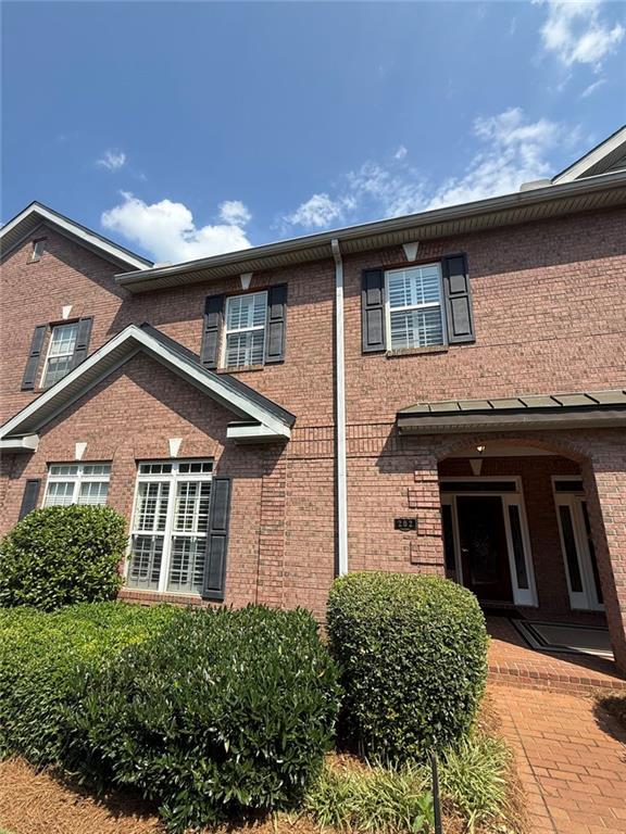 1950 Buford Dam Road, Unit 202 Cumming, GA 30041 - Photo 2 of 40 a front view of a house with garage