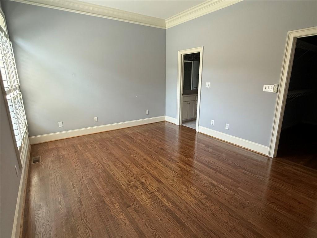 1950 Buford Dam Road, Unit 202 Cumming, GA 30041 - Photo 23 of 40 an empty room with wooden floor and entrance
