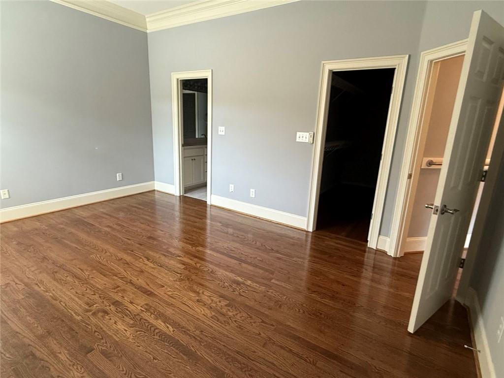 1950 Buford Dam Road, Unit 202 Cumming, GA 30041 - Photo 24 of 40 an empty room with wooden floor and entrance