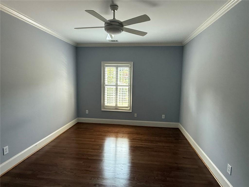 1950 Buford Dam Road, Unit 202 Cumming, GA 30041 - Photo 28 of 40 a view of an empty room with wooden floor and a window