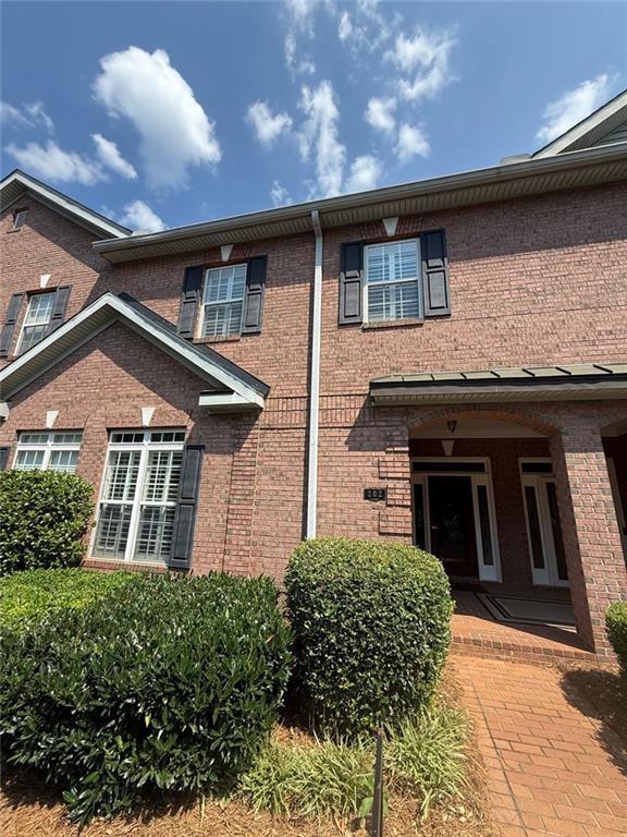 1950 Buford Dam Road, Unit 202 Cumming, GA 30041 - Photo 3 of 40 front view of a house with a yard