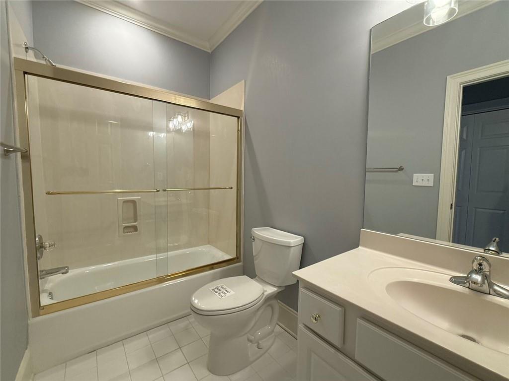 1950 Buford Dam Road, Unit 202 Cumming, GA 30041 - Photo 32 of 40 a bathroom with a sink a toilet and shower