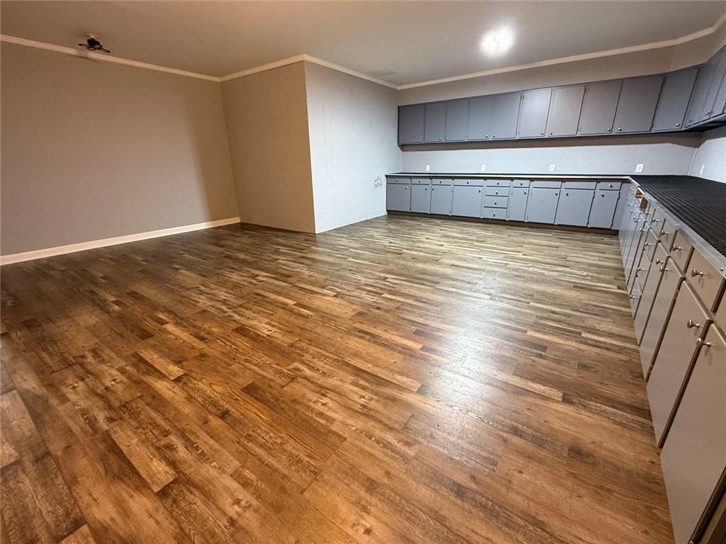 1950 Buford Dam Road, Unit 202 Cumming, GA 30041 - Photo 39 of 40 a view of an empty room with wooden floor