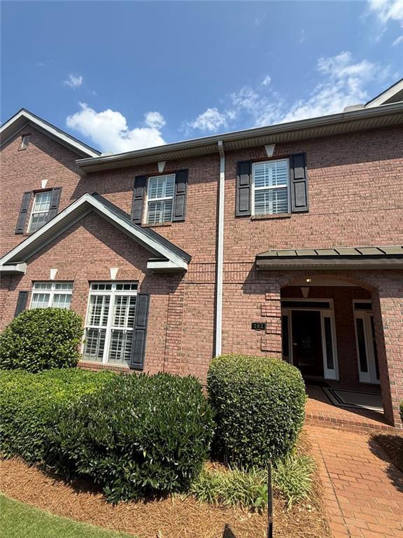 1950 Buford Dam Road, Unit 202 Cumming, GA 30041 - Photo 5 of 40 a front view of a house with a yard
