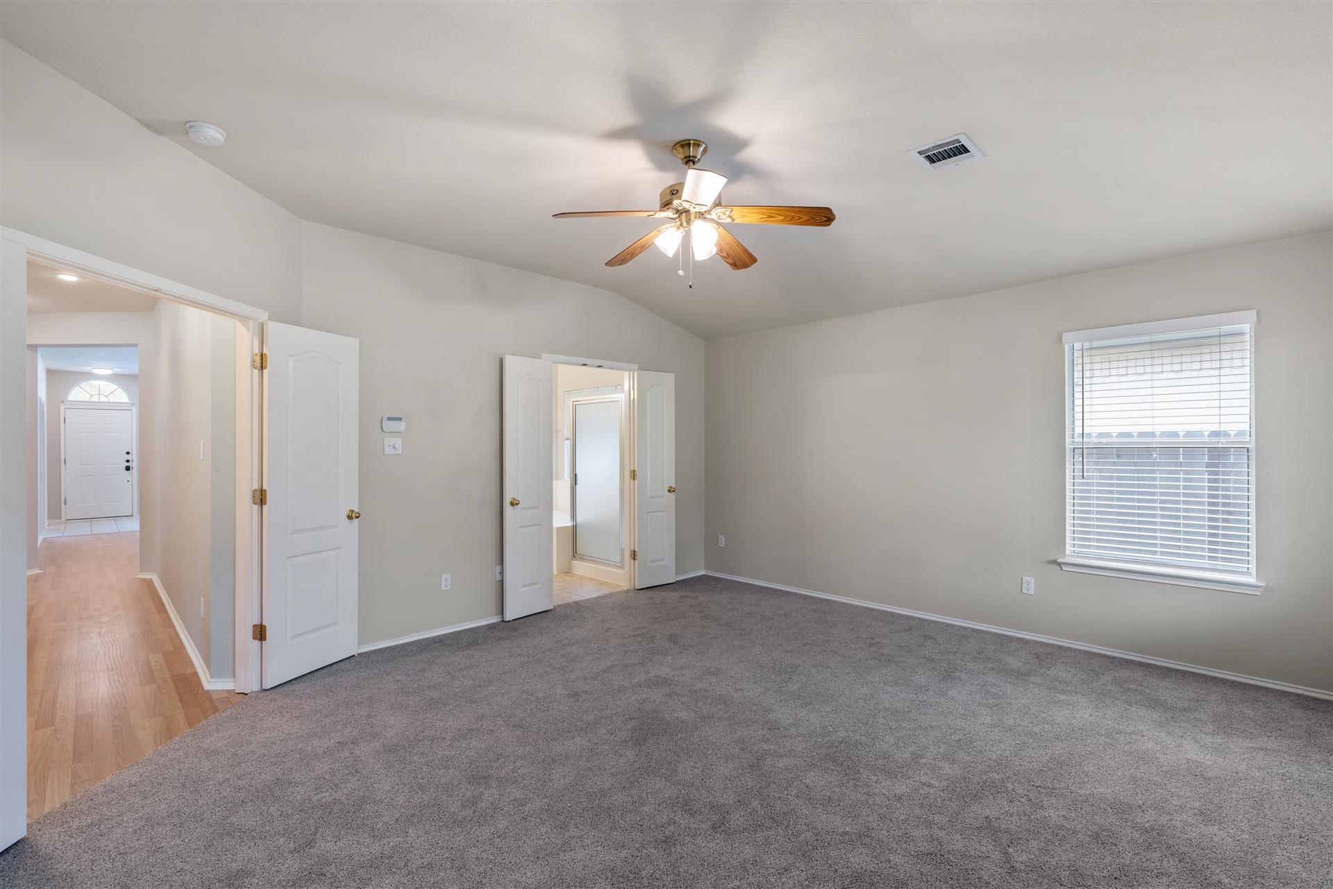 4725 Tello Path Austin, TX 78749 - Photo 17 of 34 A spacious, naturally illuminated bedroom offers direct access to an adjacent bathroom.