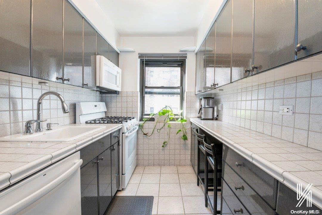 a kitchen with a sink cabinets and appliances