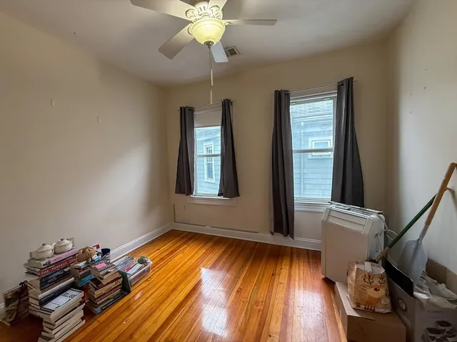 a view of room with window and wooden floor