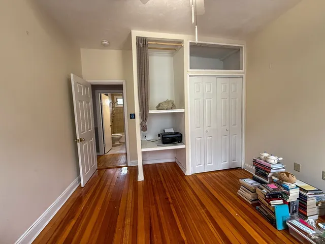 a room with wooden floor and a window