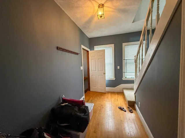a view of a livingroom with wooden floor and furniture