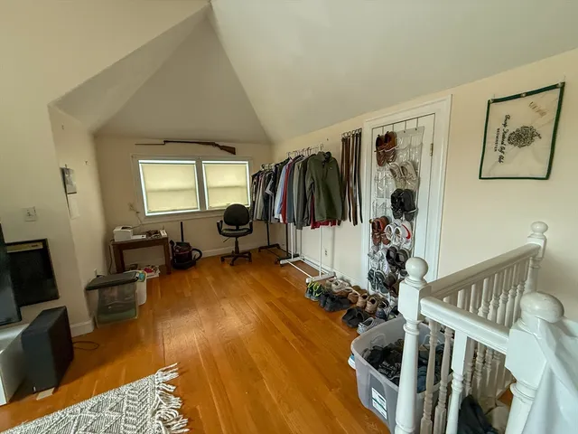 a view of a livingroom with furniture and hardwood floor