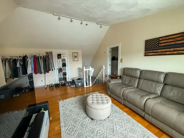 a living room with furniture a rug and a large window