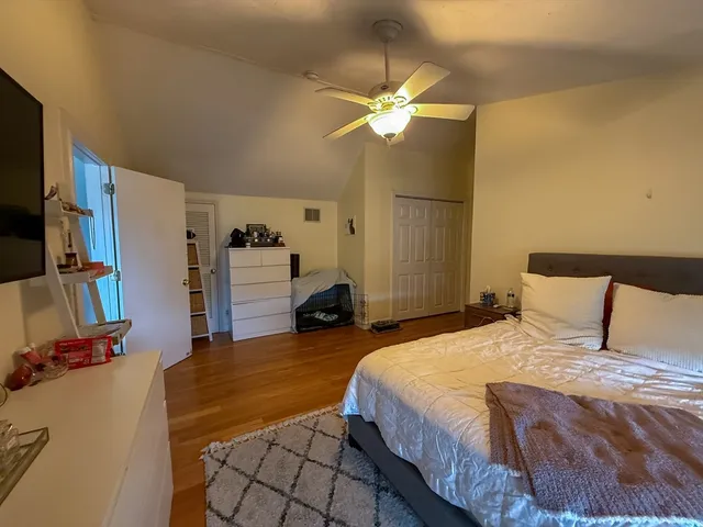 a bedroom with a bed and a flat screen tv