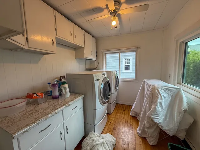 a utility room with cabinets dryer and washer