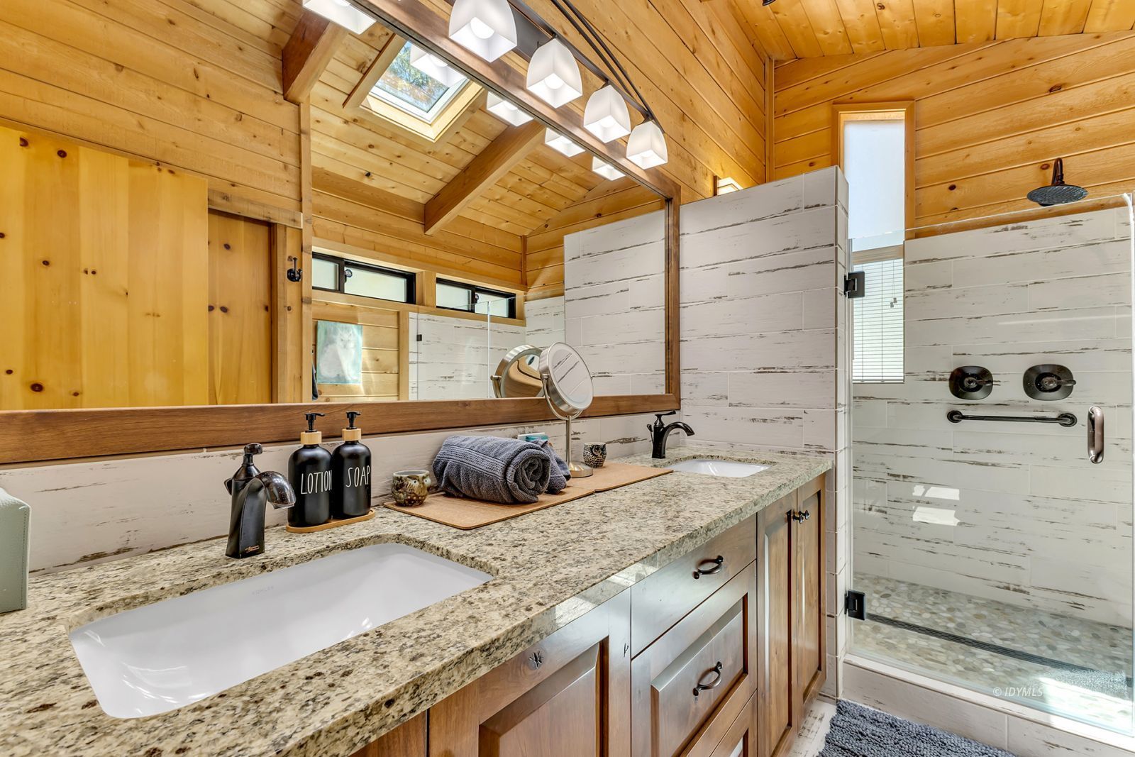 24924 Fern Valley Road Idyllwild, CA 92549 - Photo 11 of 72 a bathroom with a granite countertop sink and a mirror