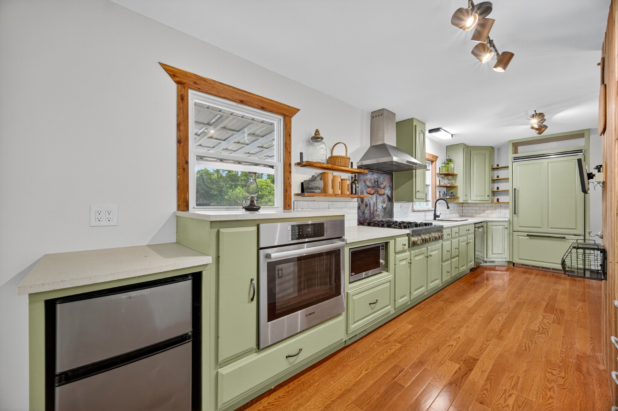 34383 Ardmore Ridge Road Prospect, TN 38477 - Photo 5 of 51 a kitchen with stainless steel appliances white cabinets and wooden floors