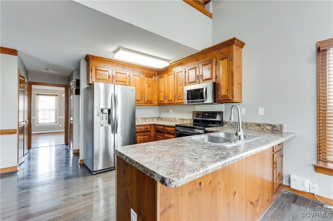 7400 Cannock Road Chesterfield, VA 23832 - Photo 9 of 36 a kitchen with stainless steel appliances granite countertop a refrigerator a stove and a sink with wooden floor