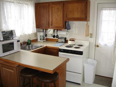 91 Glendon Road, Unit 93 Dennis Port, MA 02639 - Photo 3 of 5 a kitchen with stainless steel appliances a stove a sink a refrigerator and cabinets