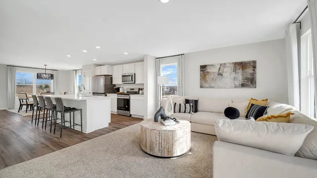 a living room with furniture and kitchen view