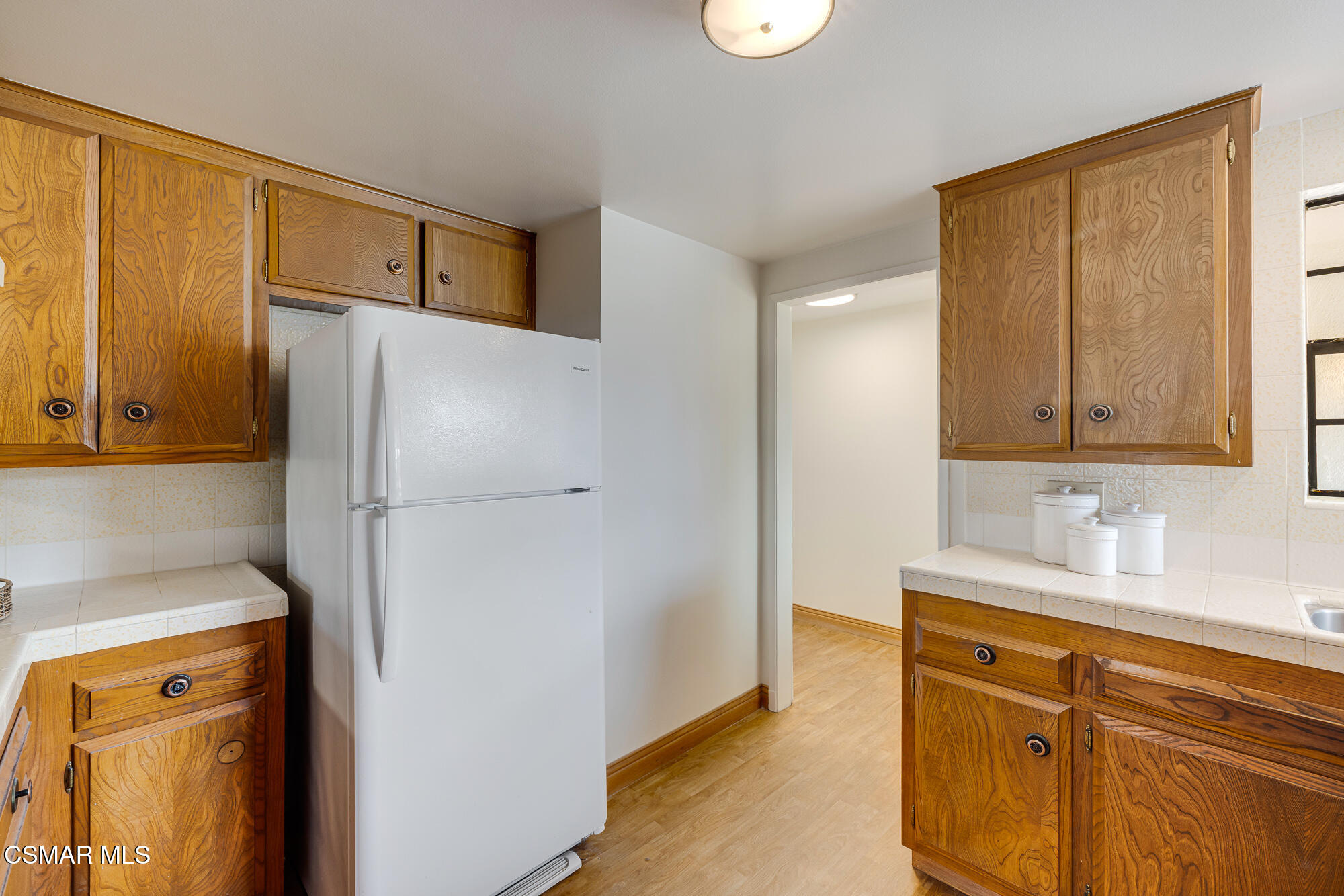 3491 Rivermore Street Camarillo, CA 93010 - Photo 11 of 49 a bathroom with a refrigerator sink and mirror