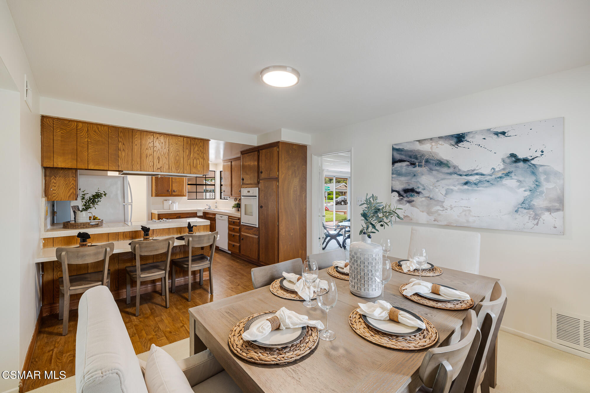 3491 Rivermore Street Camarillo, CA 93010 - Photo 16 of 49 a view of a dining room with furniture a kitchen and chandelier