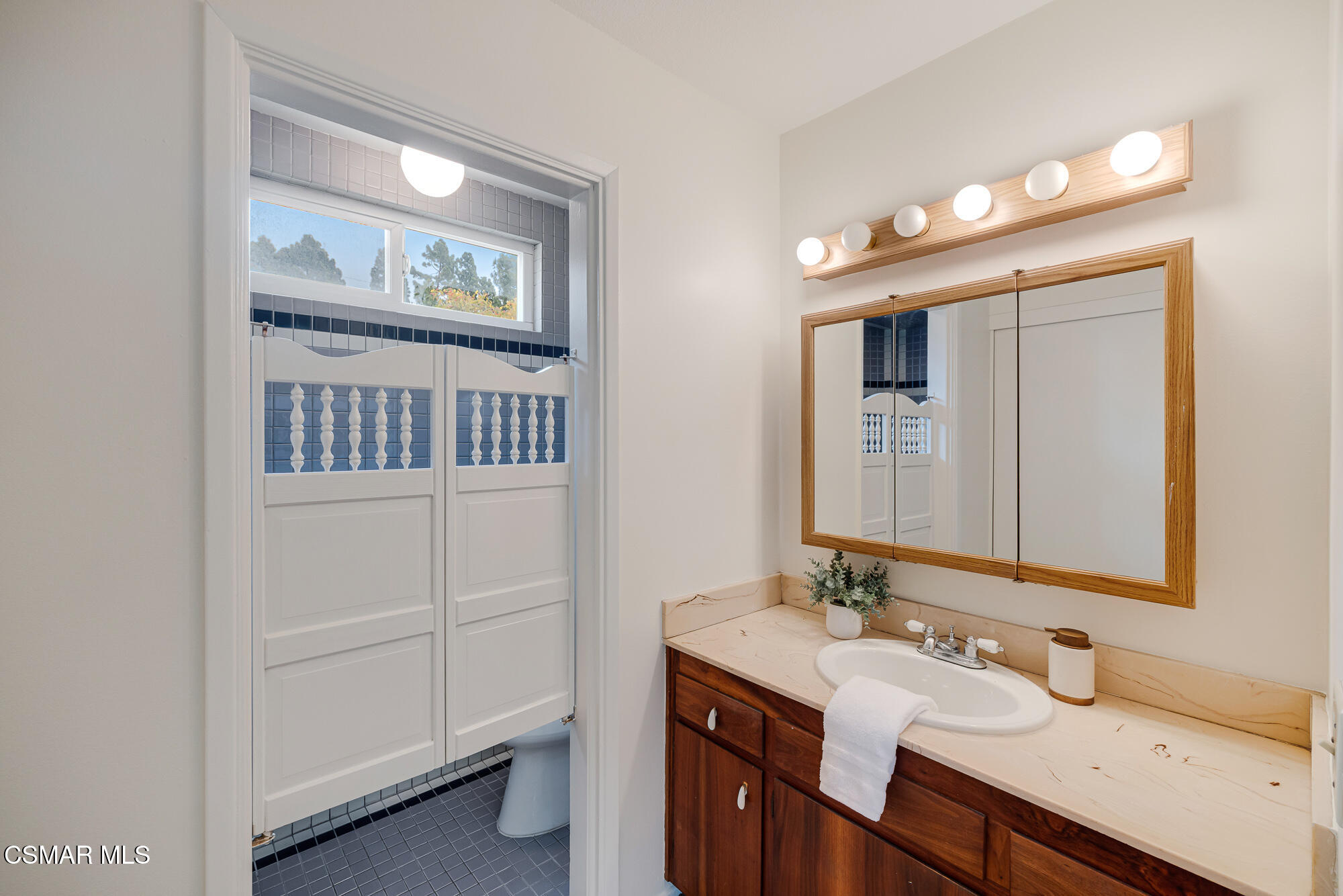 3491 Rivermore Street Camarillo, CA 93010 - Photo 32 of 49 a bathroom with a sink a vanity and a mirror