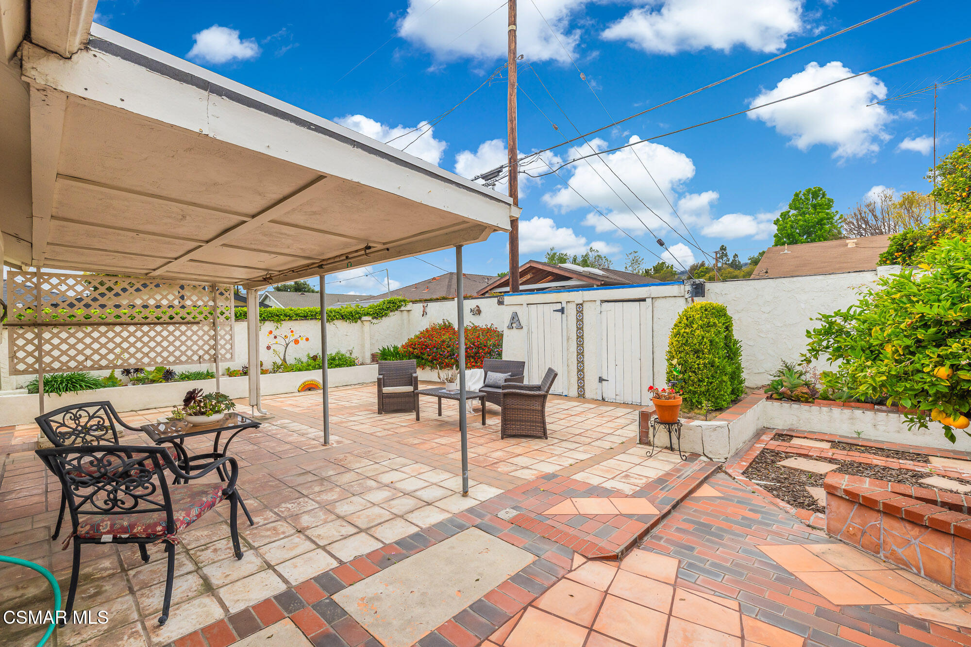 3491 Rivermore Street Camarillo, CA 93010 - Photo 34 of 49 a view of a patio with a table and chairs under an umbrella