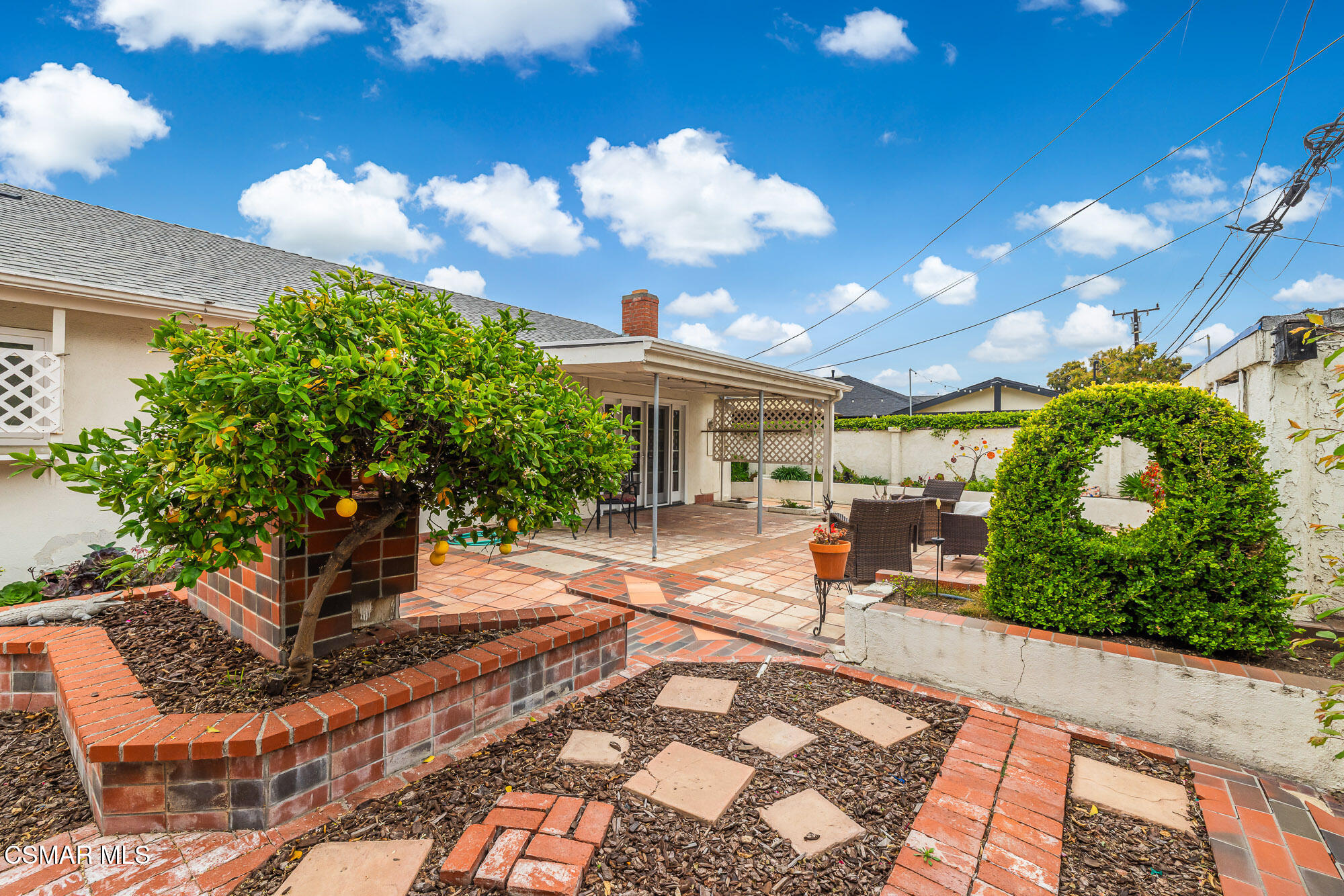 3491 Rivermore Street Camarillo, CA 93010 - Photo 44 of 49 a view of a patio with table and chairs potted plants and large tree