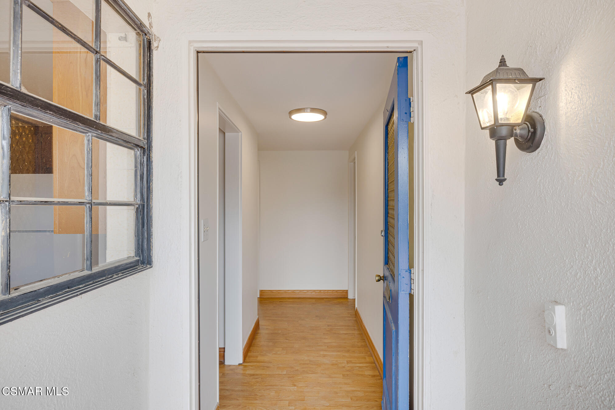 3491 Rivermore Street Camarillo, CA 93010 - Photo 8 of 49 a view of a hallway with wooden floor and staircase