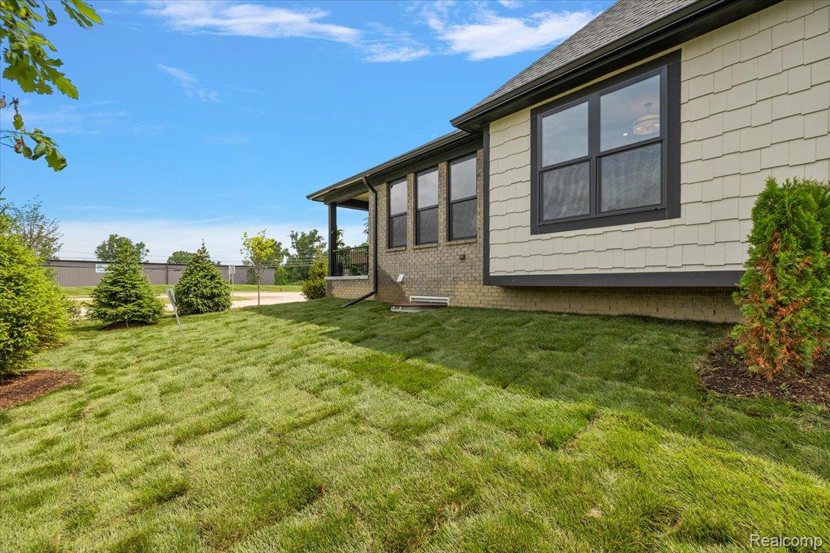 2032 Breckenridge Court, Unit 9 Rochester, MI 48309 - Photo 6 of 39 View of yard featuring a sunroom