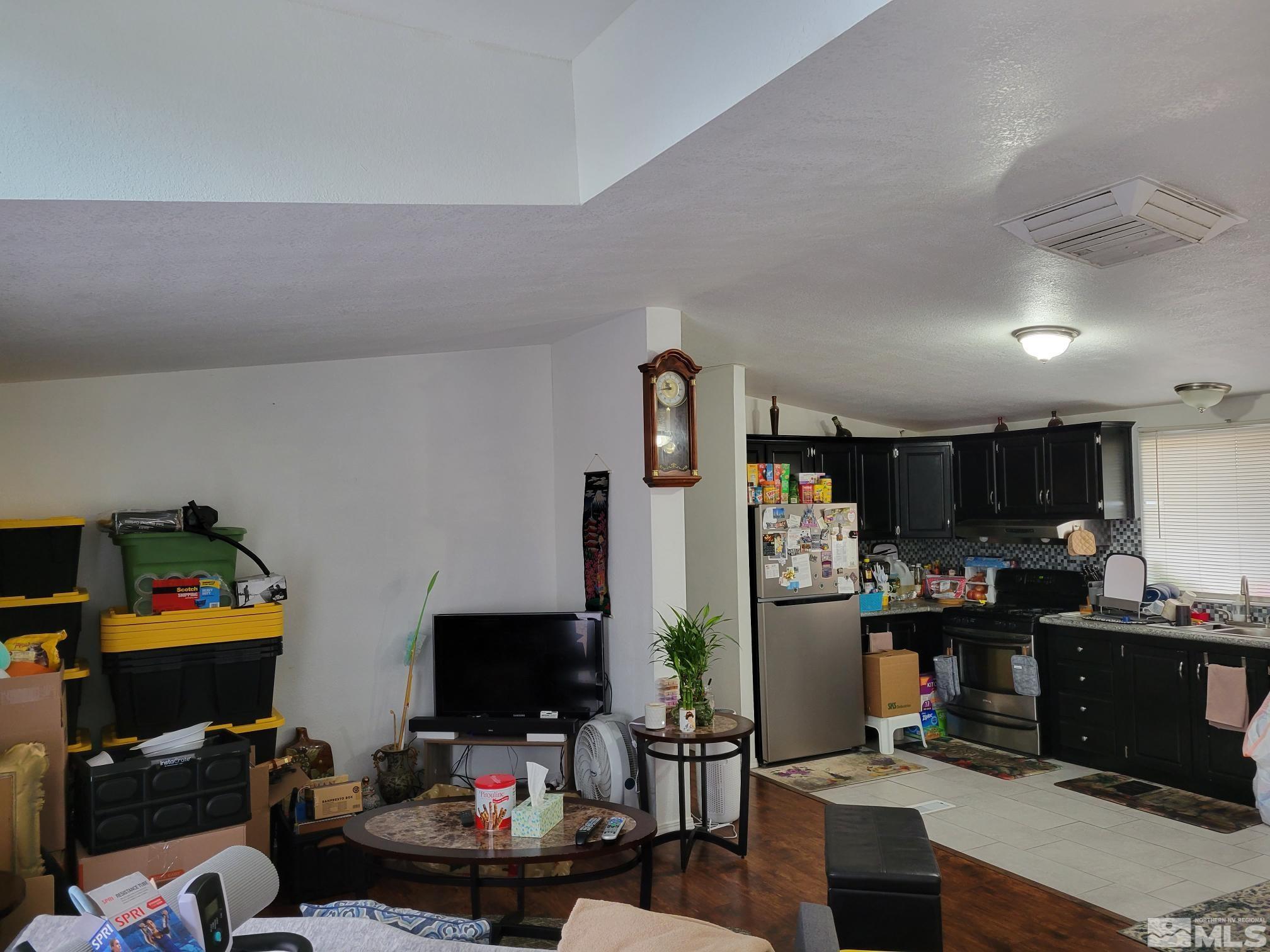 1348 Leopard Street Reno, NV 89506 - Photo 2 of 10 a room with a workspace and a couch