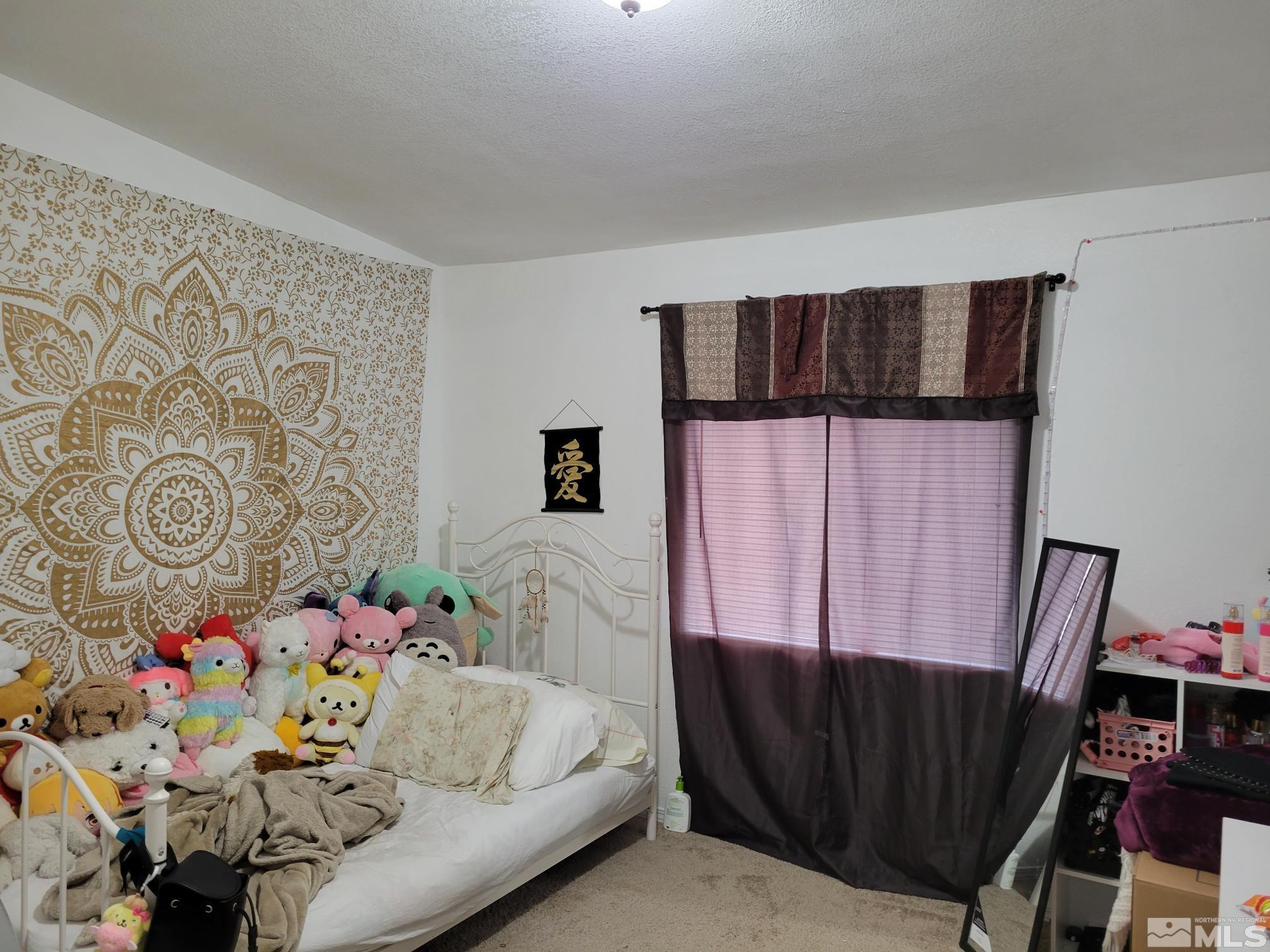 1348 Leopard Street Reno, NV 89506 - Photo 8 of 10 a bedroom with a bed and furniture