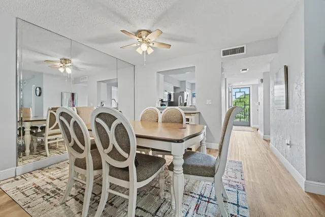 a view of a dining room with furniture and chandelier