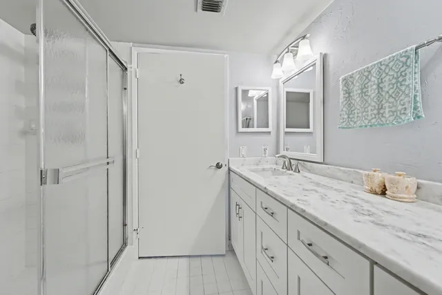 a bathroom with a granite countertop sink mirror and double