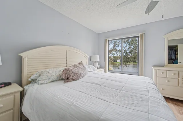 a bedroom with a large bed and a window