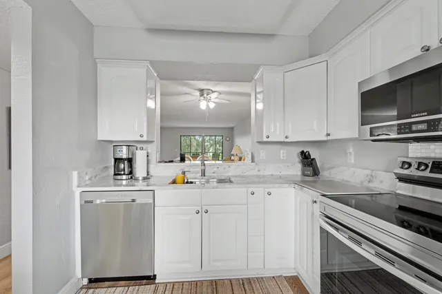 a kitchen with a sink stove and cabinets