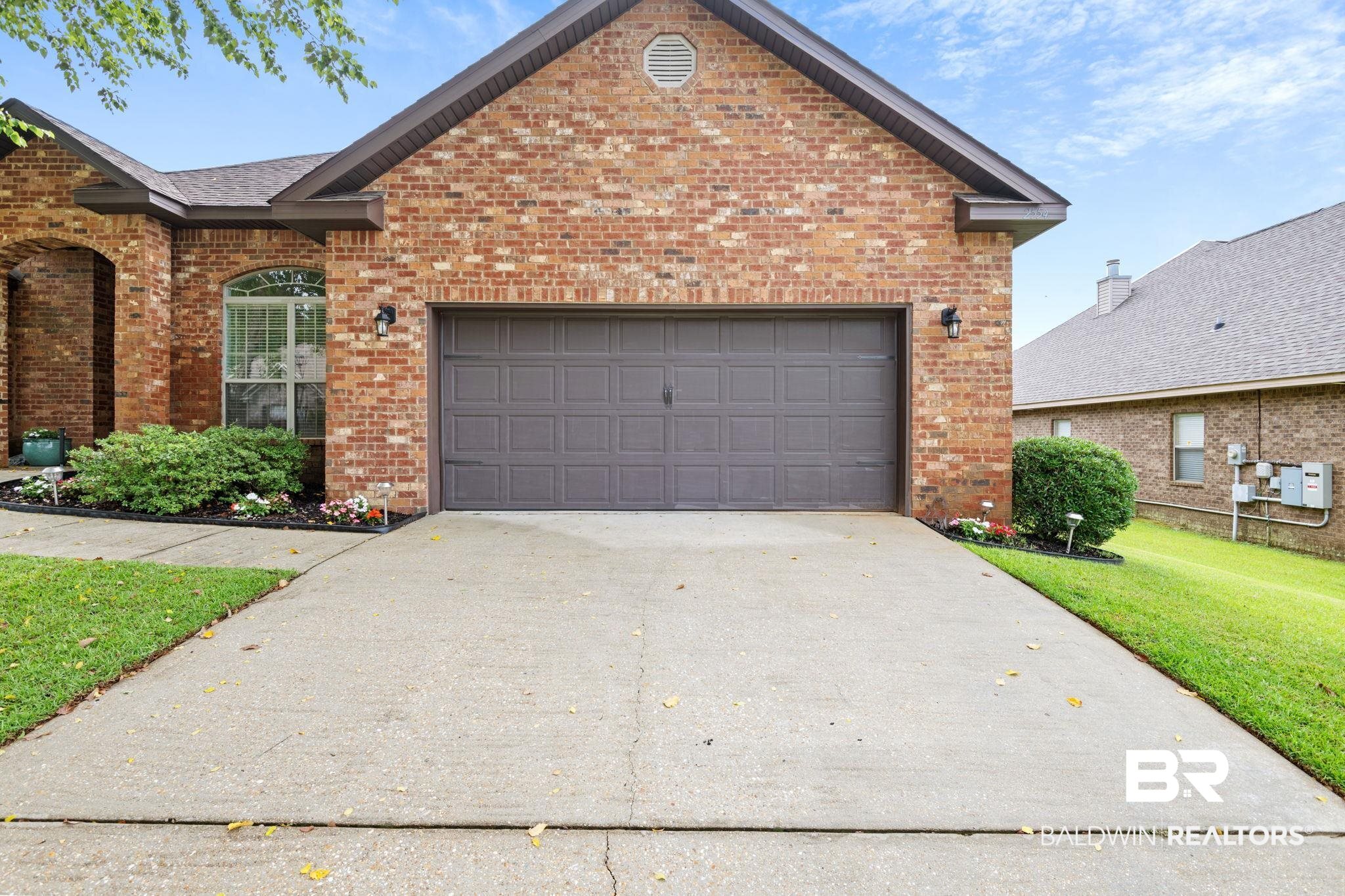 2554 Masters Court Mobile, AL 36618 - Photo 4 of 35 Traditional home featuring brick siding, a front lawn, concrete driveway, and an attached garage